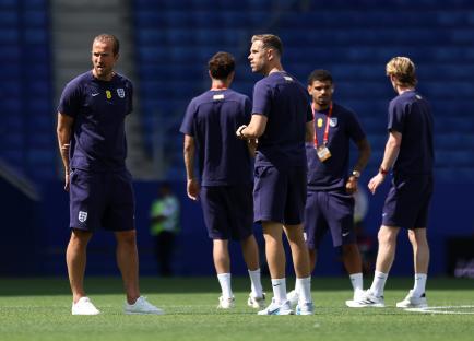 Harry Kane and Jordan Henderson of England inspecting the pitch.