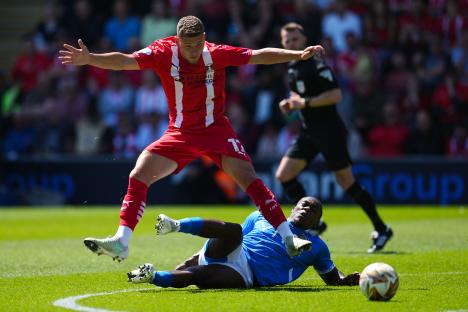 Soccer players contesting the ball during a match.