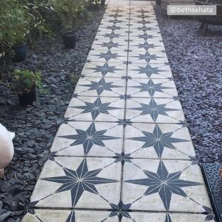Garden path paved with star-patterned tiles.