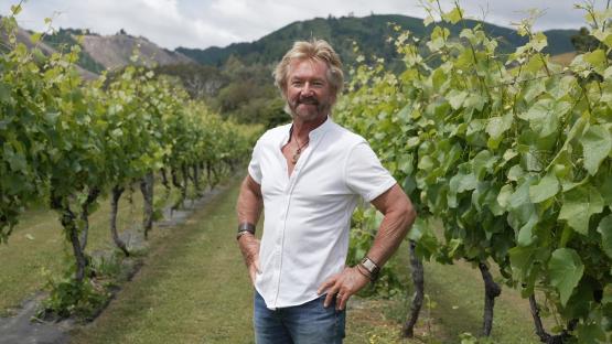 Noel Edmonds standing in a vineyard.