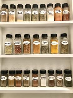 Spice rack with various spices in small jars.