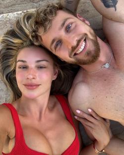 Couple lying down together smiling.