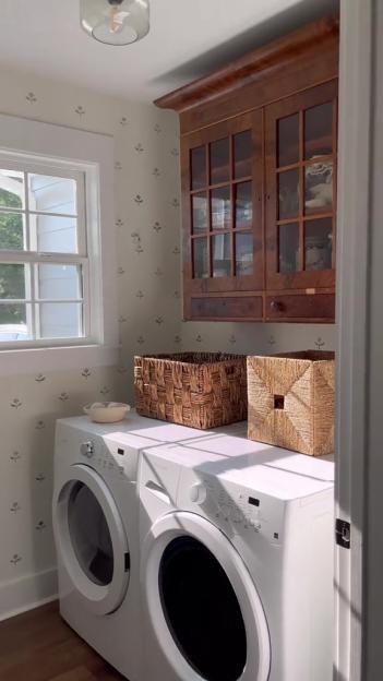 Laundry room with washer, dryer, and storage.