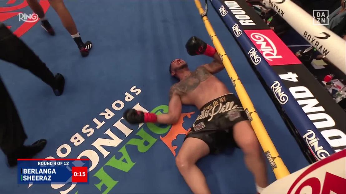Boxer lying on the ropes during a boxing match.