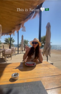 Woman eating at outdoor restaurant in Neom, Saudi Arabia.