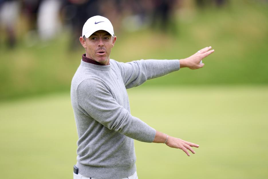 Rory McIlroy reacting on a golf course.