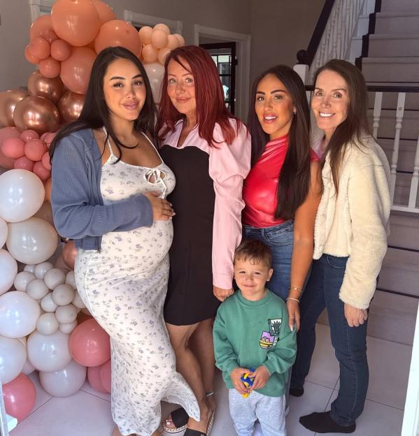Pregnant woman with family at baby shower.