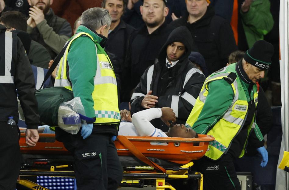 Injured soccer player being carried on a stretcher.