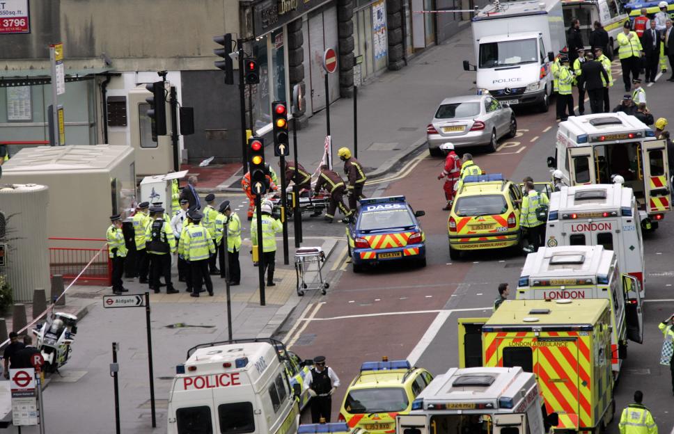 Emergency responders attending to an injured person near Aldgate Underground Station.