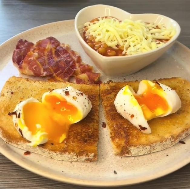Microwave poached eggs on toast with bacon and baked beans.