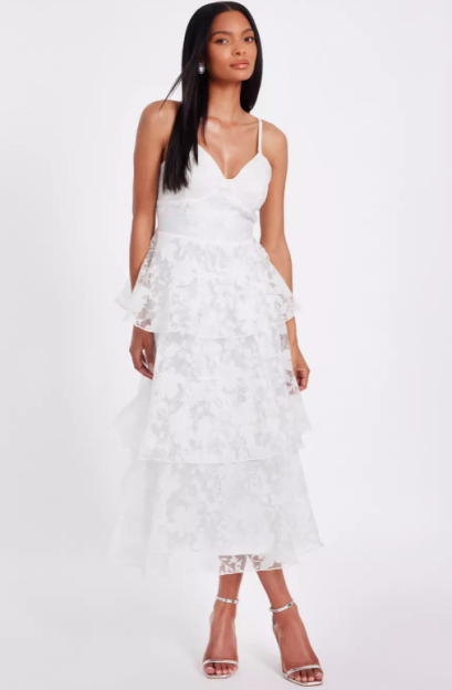 Woman in white layered midi dress.
