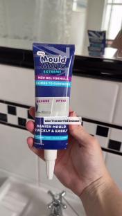Hand holding tube of Mould Magic Extreme mold remover.