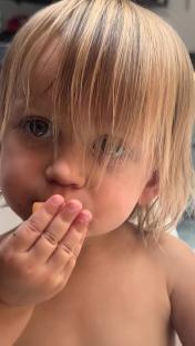 Toddler eating a snack.