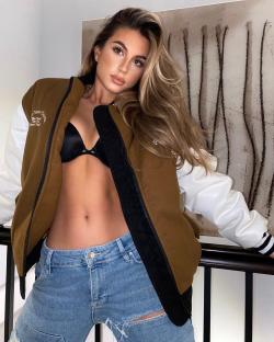 Sophia Peschisolido wearing a brown and white jacket and jeans.
