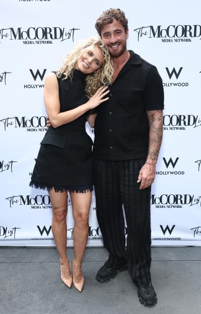 AnnaLynne McCord and Danny Cipriani kissing at an Emmy nomination celebration.