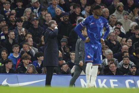 Ange Postecoglou, Tottenham Hotspur's head coach, cups his ears to the fans during a Premier League match.
