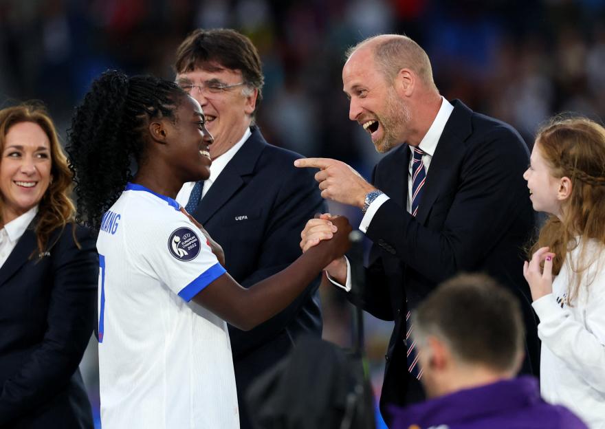 Michelle Agyemang shaking hands with Prince William at a trophy ceremony.