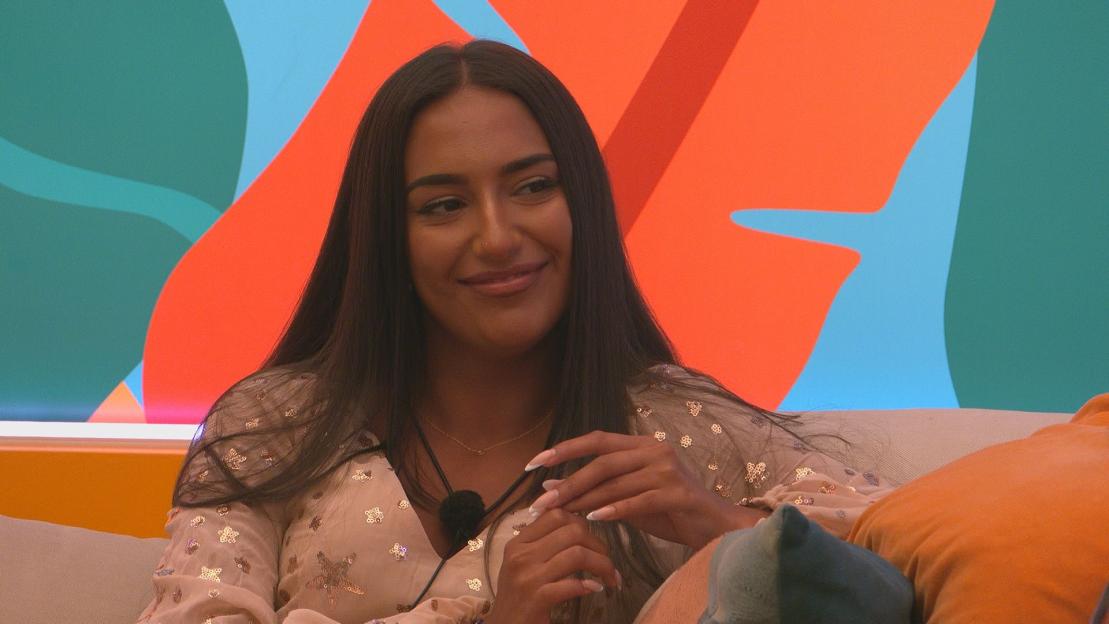 Shakira Khan and Harry Cooksley on a couch during a Love Island Aftersun Update.