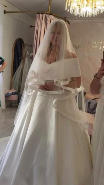 Woman in a white wedding dress and veil.