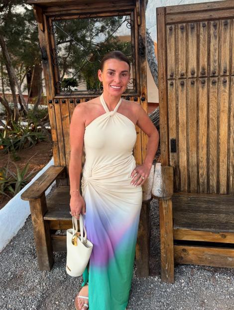 Woman in ombre maxi dress in Ibiza.
