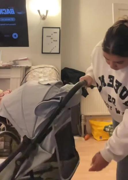 Woman unfolding a stroller.