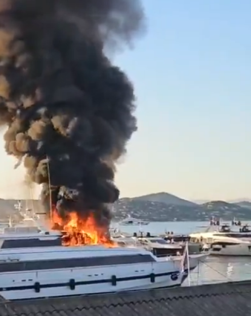 A yacht engulfed in flames.