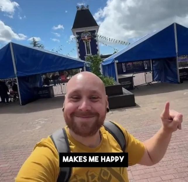 Man at Alton Towers smiling and giving a thumbs up.
