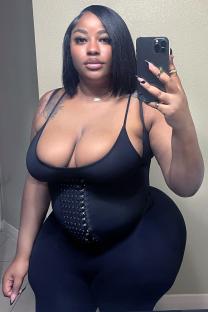 Woman in black bodysuit after Brazilian butt lift surgery.