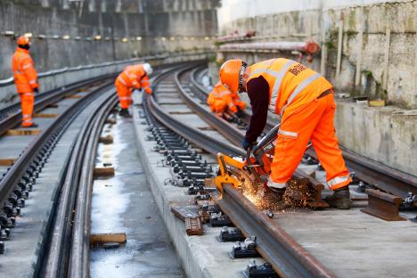 Construction workers installing train tracks.