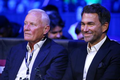 Eddie Hearn and his father Barry Hearn watching a boxing match.