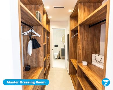Master dressing room with wooden closets and shelves.
