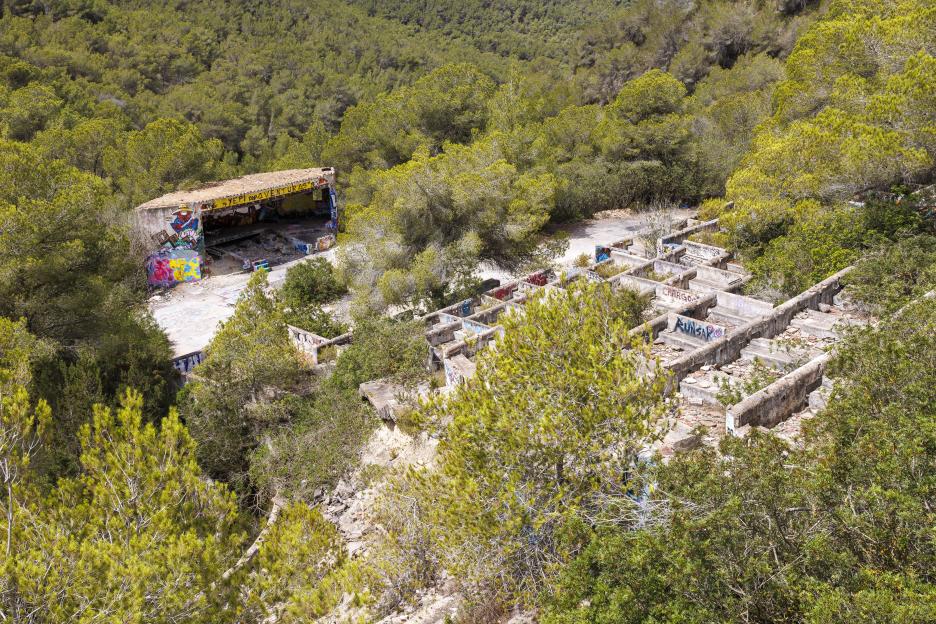 Aerial view of the ruins of a graffiti-covered building in Ibiza.