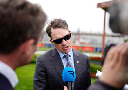 Aidan O'Brien being interviewed at a racecourse.