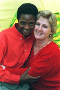 Portrait of a Masai man and a woman embracing.