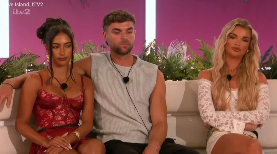 Three Love Island contestants sitting on a couch.