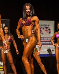 Bodybuilder Megan Prescott competing in a bodybuilding competition.