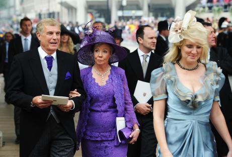 People in formal attire walking.