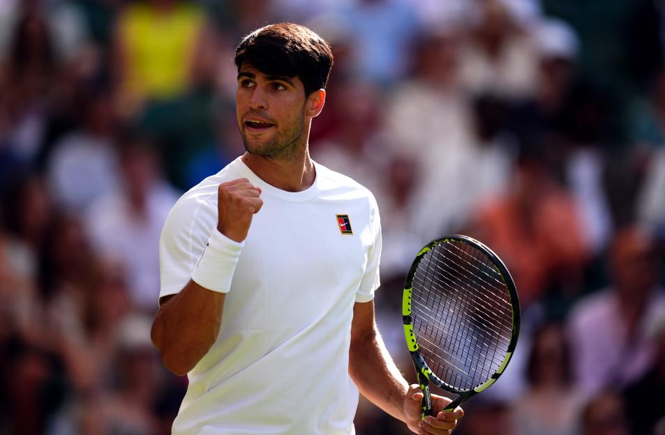 Carlos Alcaraz celebrating during a Wimbledon match.