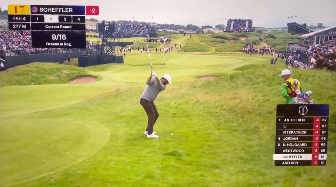Golfer taking a shot on a golf course.