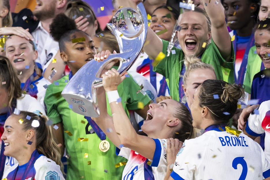 Chloe Kelly lifts the trophy after England wins the UEFA Women's EURO 2025 final.