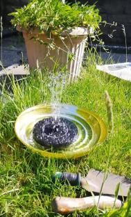 Solar-powered fountain in repurposed pot.