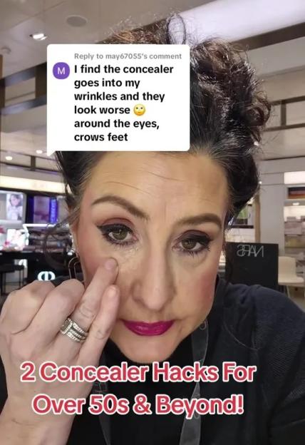 Woman demonstrating concealer application techniques for mature skin.