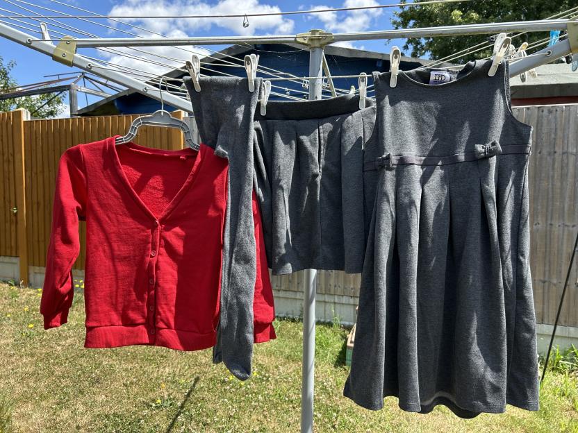 School uniform hanging on a clothesline to dry.