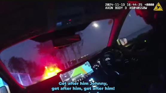 Police car dashboard camera footage of a high-speed pursuit.