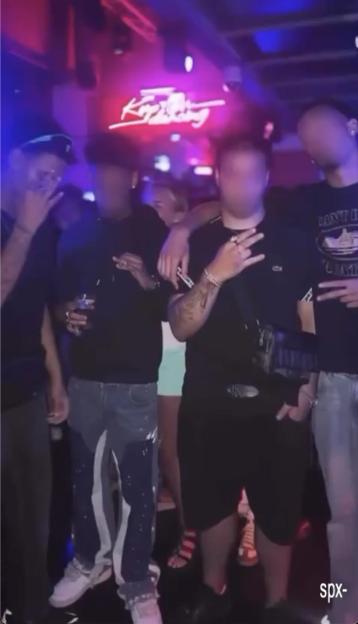 Photo of a group of young men in a nightclub, some faces are blurred.