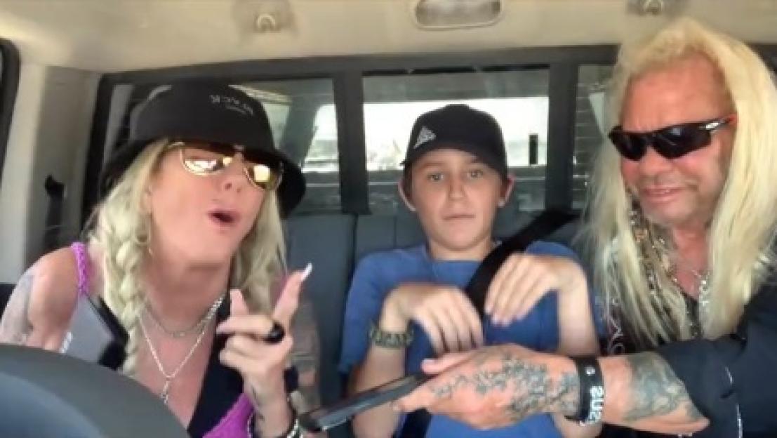 Dog the Bounty Hunter, his wife, and their grandson in a car.
