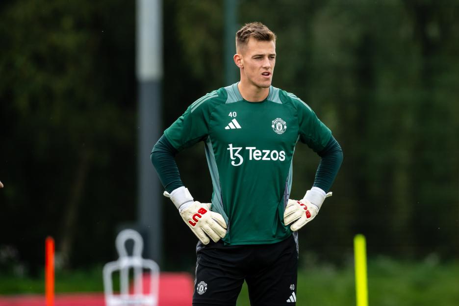 a soccer player wearing a green shirt that says tezos