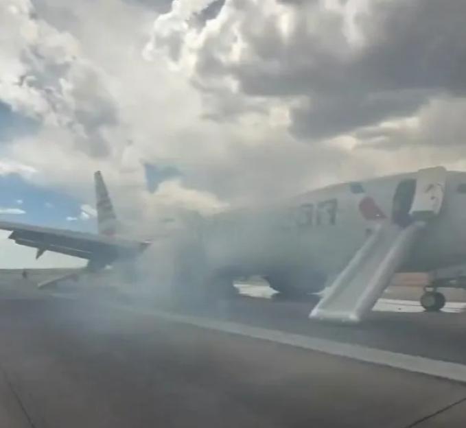 American Airlines plane's landing gear on fire, passengers evacuated.