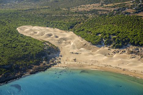 Aerial view of Bolonia beach in Spain, showing sand dunes and turquoise water.