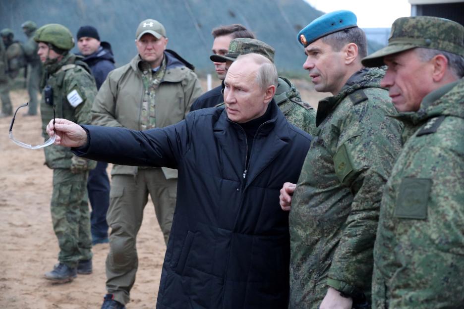 Vladimir Putin speaking with military officers.